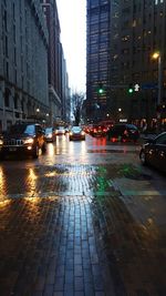 Illuminated city street at night