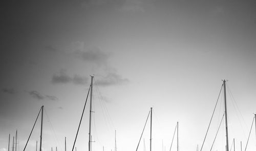 Masts of sailboats against sky