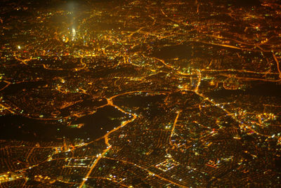 High angle view of city lit up at night