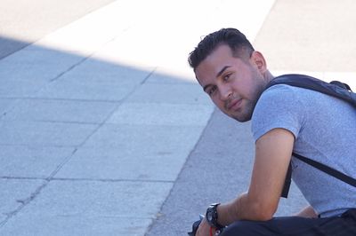 Portrait of young man sitting on bicycle