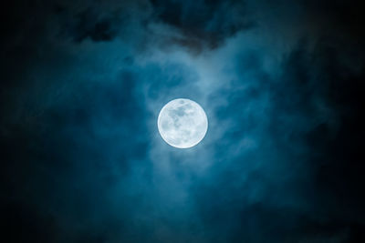 Low angle view of moon against blue sky