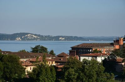 Town by sea against clear sky