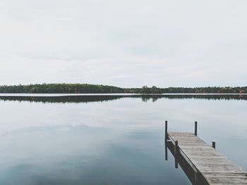 Pier on lake against sky