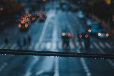 Close-up of wet railing by road