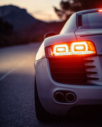 Close-up of illuminated car on road