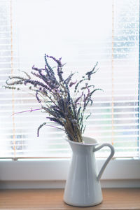 Close-up of flower vase on table at home