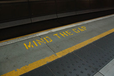 High angle view of text on railroad station platform