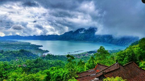 High angle view of sea and mountains against sky