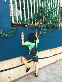 Full length of boy with arms raised