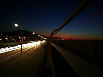 Road along illuminated lights at night