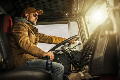 Portrait of man sitting in car