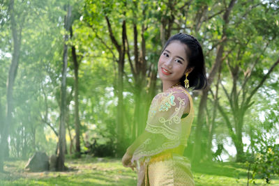 Girl in traditional clothing standing at park