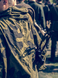 Close-up of man with arms outstretched in background