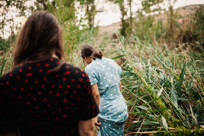 Rear view of couple standing on land