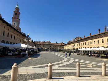 Buildings in city against clear sky