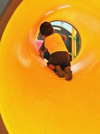 Playful boy in slide