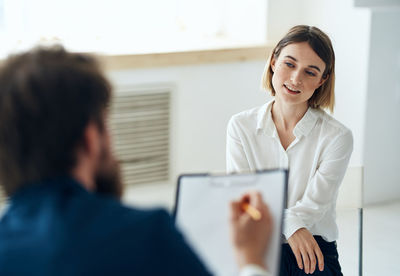 Side view of doctor examining patient at clinic