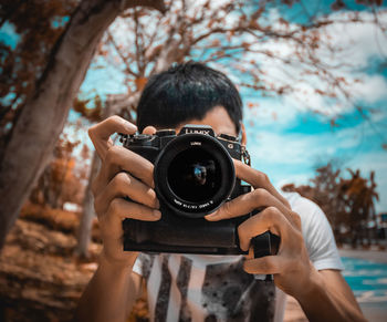 Portrait of man photographing camera