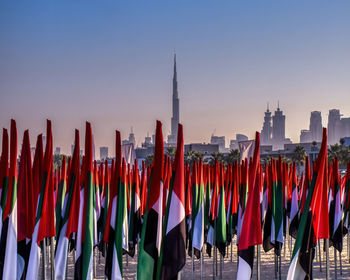 Panoramic view of flags in city against clear sky