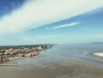 Scenic view of sea against sky in city