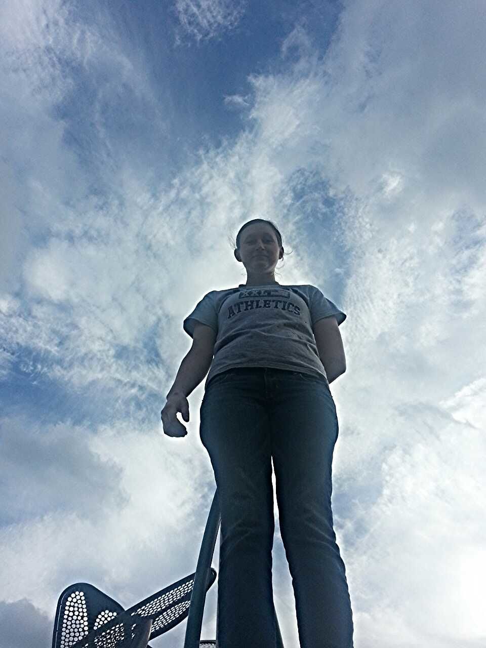 sky, low angle view, cloud - sky, standing, lifestyles, leisure activity, cloud, cloudy, men, three quarter length, rear view, waist up, blue, day, outdoors, casual clothing, nature, silhouette