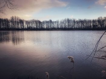 Scenic view of lake against sky during winter