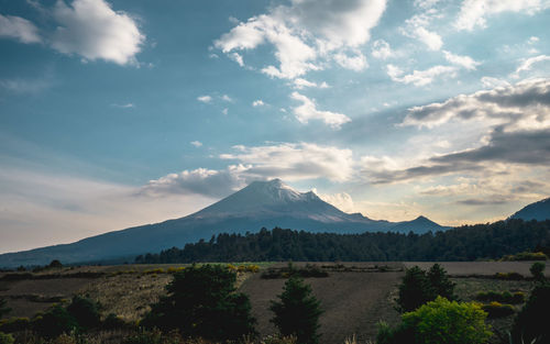 Scenic view of mountains against cloudy sky