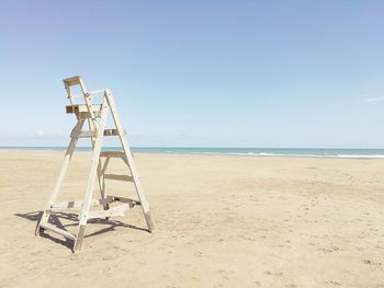 Lifeguard hut on beach against clear sky