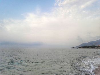 Scenic view of calm sea against cloudy sky
