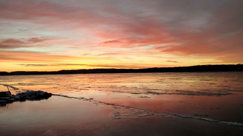 Scenic view of lake at sunset