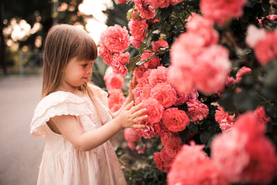 Girl touching flowers