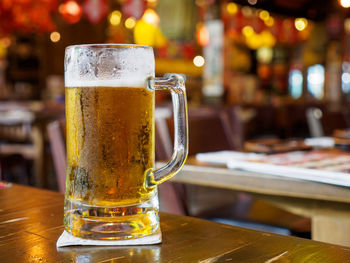Glass of beer on table