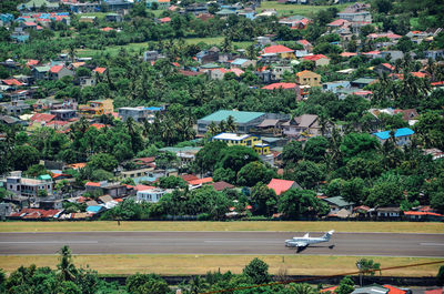 High angle view of trees and buildings in city