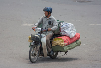 Man riding motorcycle on road