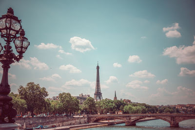 Tower amidst buildings in city against sky