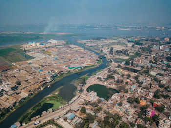 High angle view of cityscape and river against sky