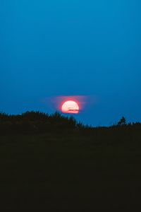 Silhouette landscape against clear sky at night