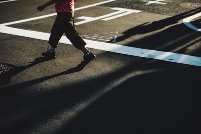 Low section of man walking on footpath