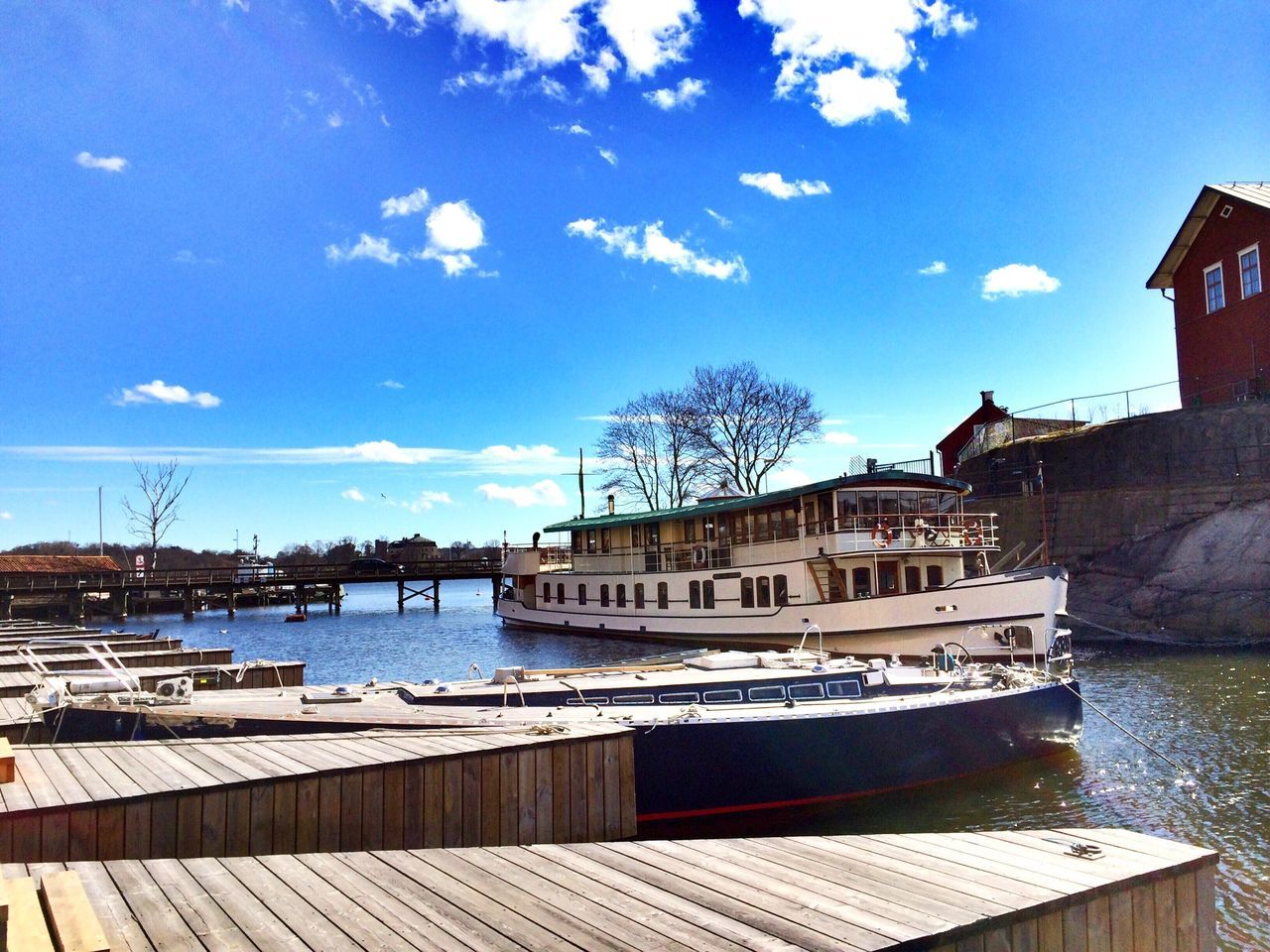 building exterior, water, architecture, built structure, sky, blue, house, cloud, reflection, tree, cloud - sky, nautical vessel, day, railing, residential structure, swimming pool, sunlight, pier, lake, residential building