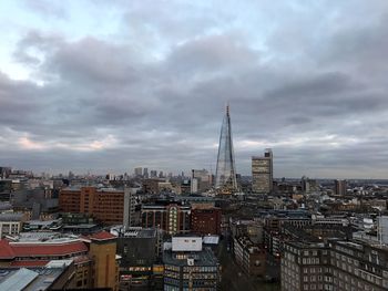 Cityscape against cloudy sky