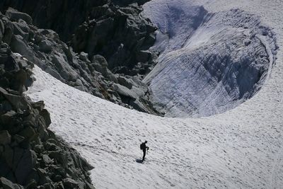 High angle view of man on snowy mountain at mer de glace during sunny day