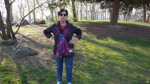 Portrait of smiling young woman standing on field