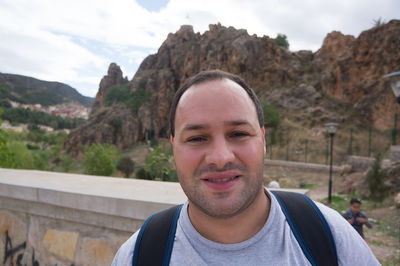Portrait of tourist against atlas mountains