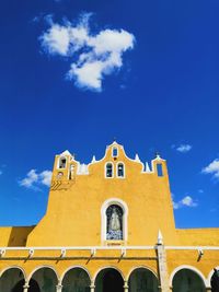 Low angle view of building against blue sky