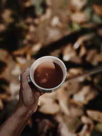 Cropped hand holding coffee