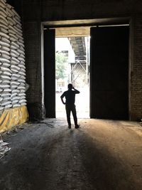 Rear view of silhouette man standing in building