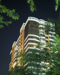 Low angle view of buildings against sky at night