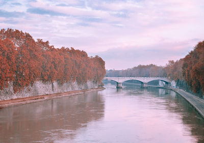 Bridge over river against sky during autumn