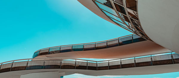 Low angle view of modern building against clear blue sky