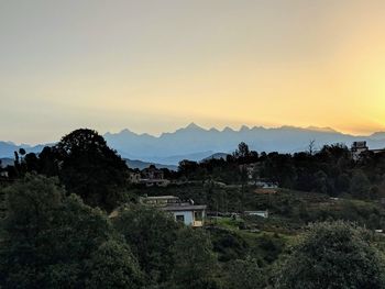 Scenic view of townscape against sky during sunset